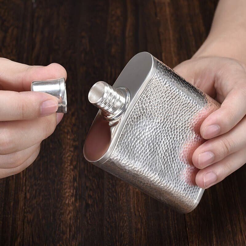 Shinny Hammered Sterling Silver Whiskey Flask holded