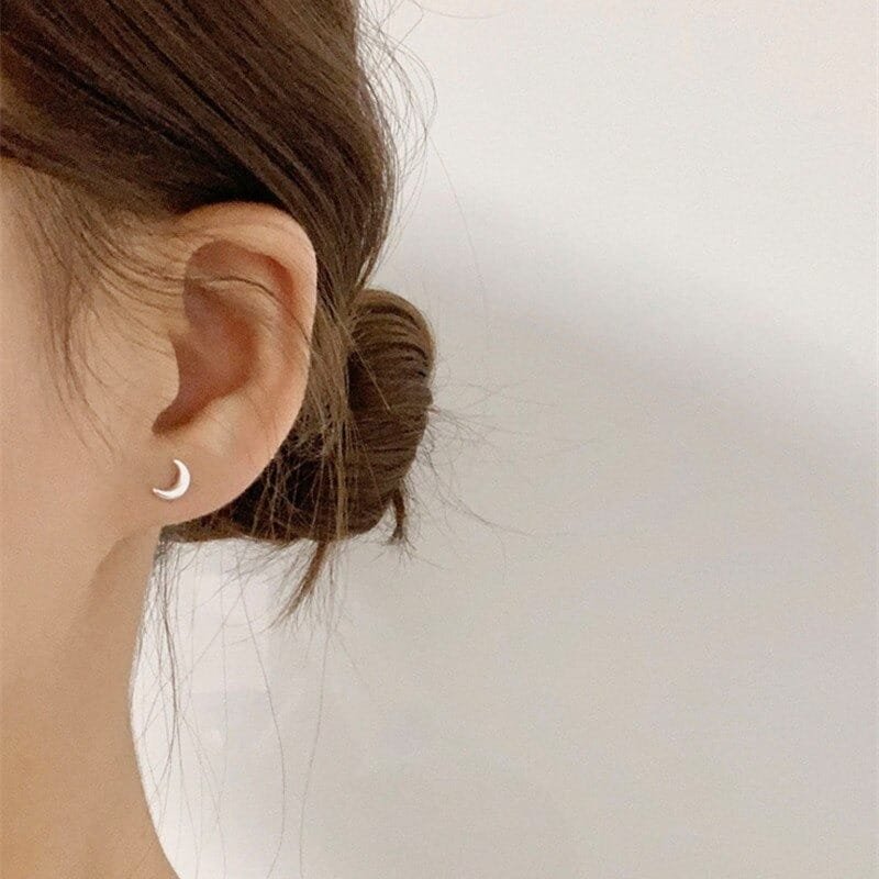 Silver Crescent Moon Earrings on ear 1