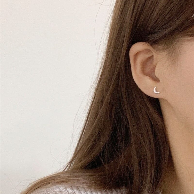 Silver Crescent Moon Earrings on ear 2