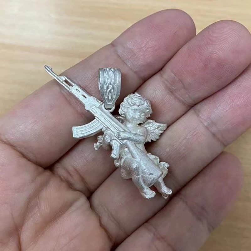 Angel With Gun Pendant in hand