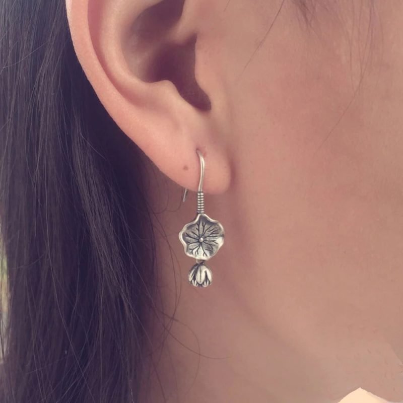 Lotus Flower Silver Earrings on ear