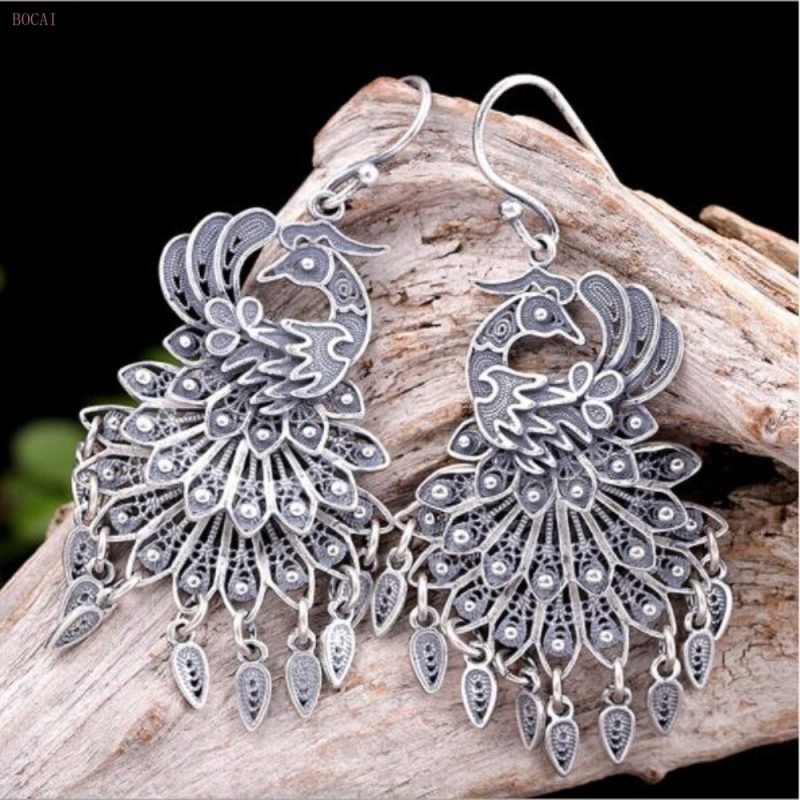 Peacock Wheel Silver Earrings on stand