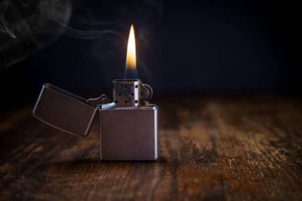 silver lighter with fire